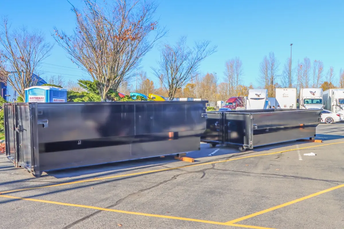 Professional dumpster rental service with roll-off container on residential driveway in South Whitehall
